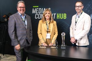 Rob Smith (left), Christine Schyvinck (center), and Michel Baars (right) with Shure's awards from PSNI at InfoComm 2024.