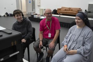 John Sparrow of Clear-Com (center) with two students at Rise Academy Summer School 2024.